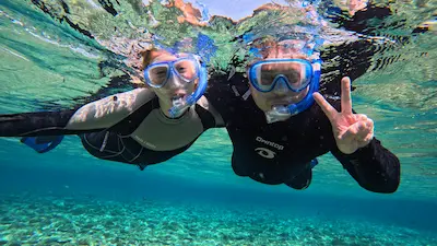 Smiling snorkelers in clear water in Ishigaki Island