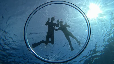 Snorkelers posing with a bubble ring in Ishigaki